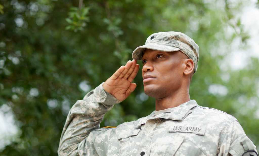 A US military service member stands to attention.