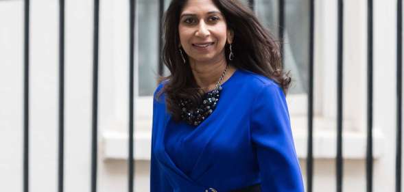 Suella Braverman leaving Downing Street wearing a blue blouse.