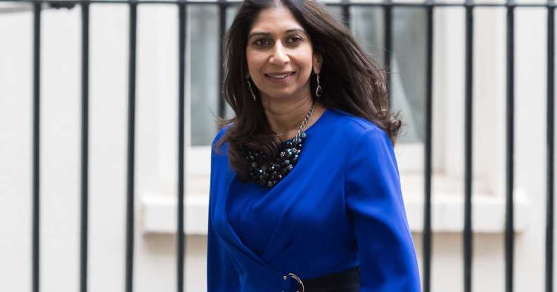 Suella Braverman leaving Downing Street wearing a blue blouse.