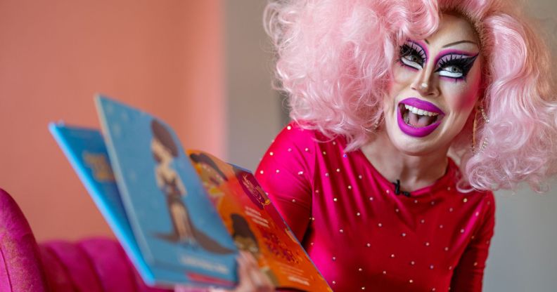 Texas drag queen Brigitte Bandit, who brought a legal case against the state's drag ban legislation, wears a pink wig and pink outfit as she reads from a book