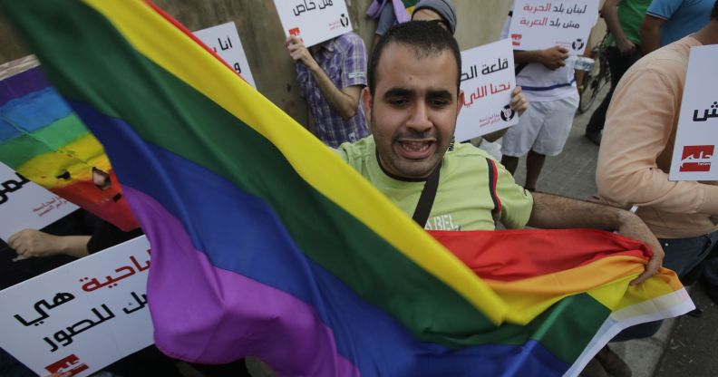 A protestor waves a Pride flag during an anti-homophobia rally in Beirut on 30 April 2013