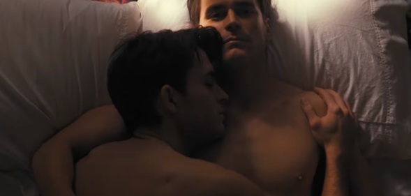 Jonathan Bailey (left) and Matt Bomer (right) lie in bed together in the trailer for Fellow Travelers