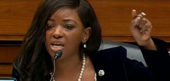 Jasmine Crocket raising her finger to enunciate a point during her speech at a Capitol Hill hearing.