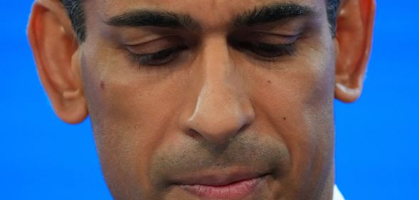 A close up of Rishi Sunak looking down.