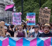 Various people hold up signs calling for trans youth and adults to be protected amid repeated attacks on healthcare rights, closure of gender identity services in England and more in the UK