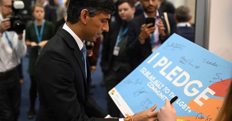 Rishi Sunak signing a pledge with LGBT+ Conservatives.
