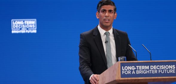 UK prime minister Rishi Sunak wears a suit and tie as he makes a speech at the Conservative Party conference. The prime minister and UK government have been criticised for making anti-trans remarks and failing to tackle LGBTQ+ hate crimes in the country