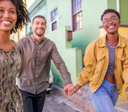 Three people walking down the street to symbolise a polyamorous relationship