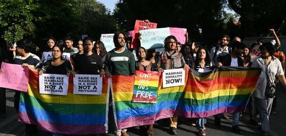 Members of the Student Federation of India (SFI) along with LGBTQ+ activists hold placards and shout slogans during a protest march against India's Supreme Court verdict on same-sex marriage, in New Delhi on October 18, 2023.