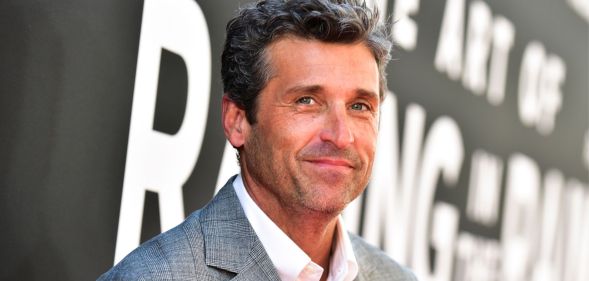 Patrick Dempsey, the Sexiest Man Alive, in a grey suit jacket and white shirt, smiling.