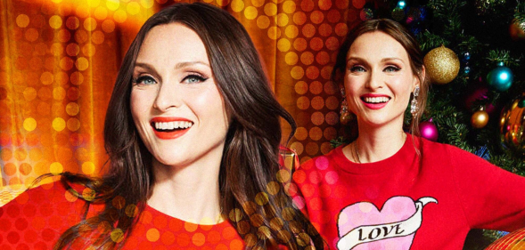 Singer Sophie Ellis-Bextor wearing a Christmas jumper with a heart on it that reads the word 'love'.