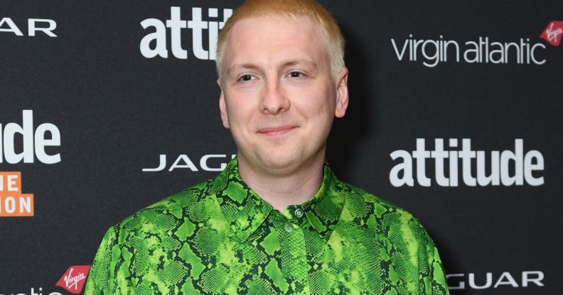 Comedian Joe Lycett, who has used his platform to troll various politicians including Suella Braverman, smiles as he wears a green and black snakeskin patterned top