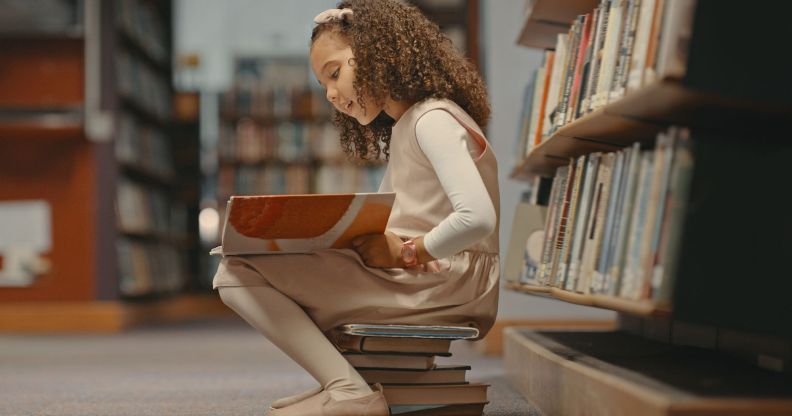 Girl reading a book in a library