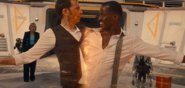 A screenshot of David Tennant and Ncuti Gatwa from the BBC series Doctor Who where Tennant and Gatwa are connected and being pulled apart